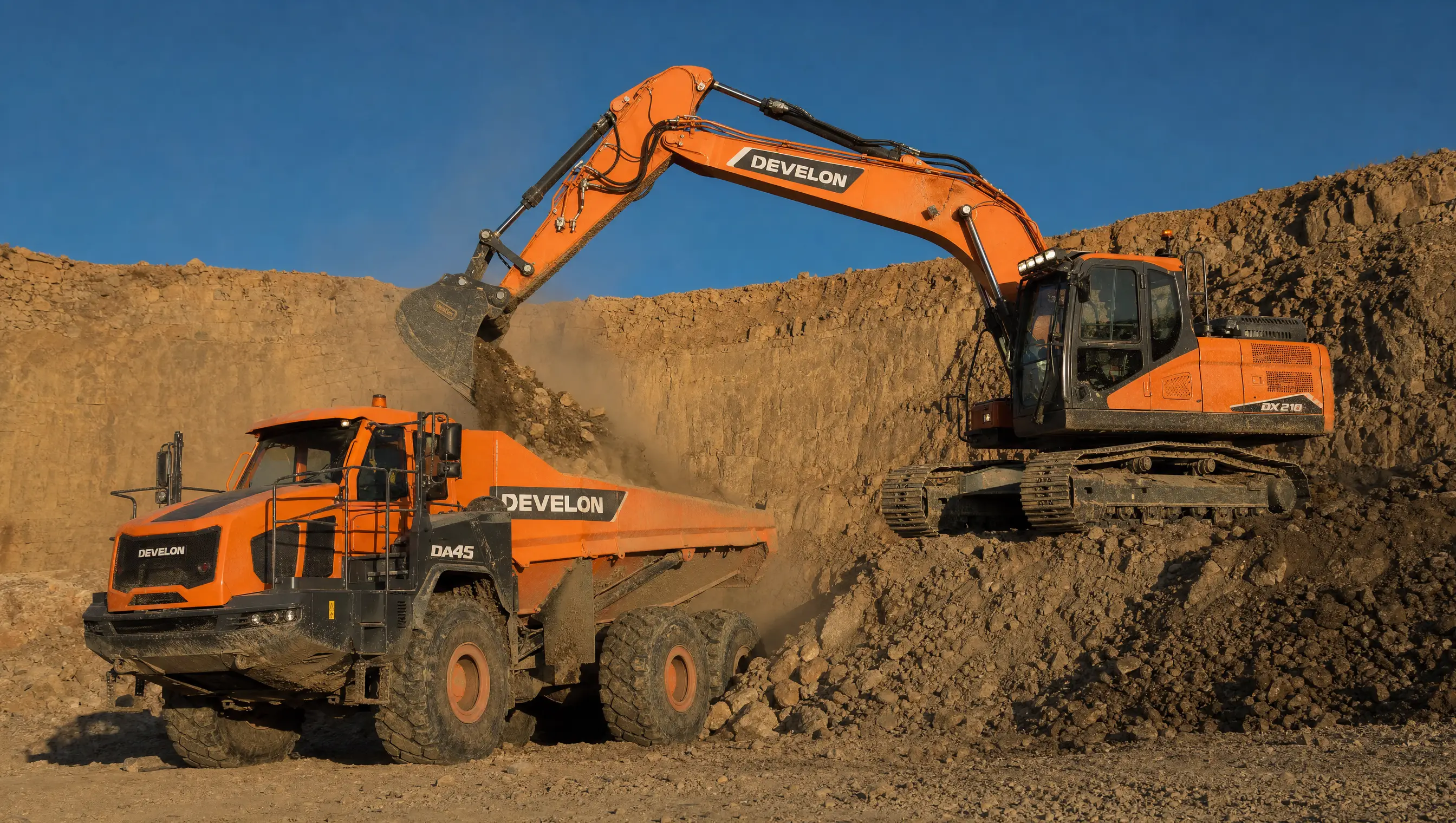 A DEVELON DX210 excavator loading a DEVELON DA45 articulated dump truck on a bench